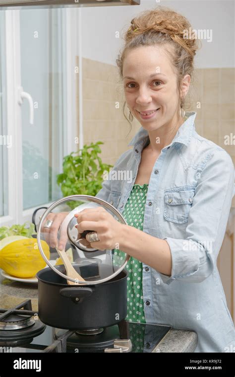 Young Woman Cooking Dinner In The Kitchen Stock Photo Alamy