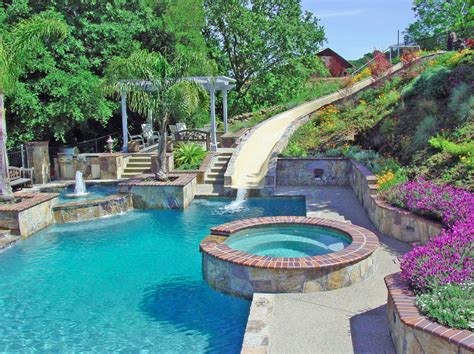 Inflatable pool slides can be a great deal of fun, and if this beautiful pool slide is made from a lovely tile mosaic, smoothed and with water pouring down the slide so that it is a smooth ride around the bend and into. 20 Awesome Swimming Pools With Water Slides | Homes of the ...