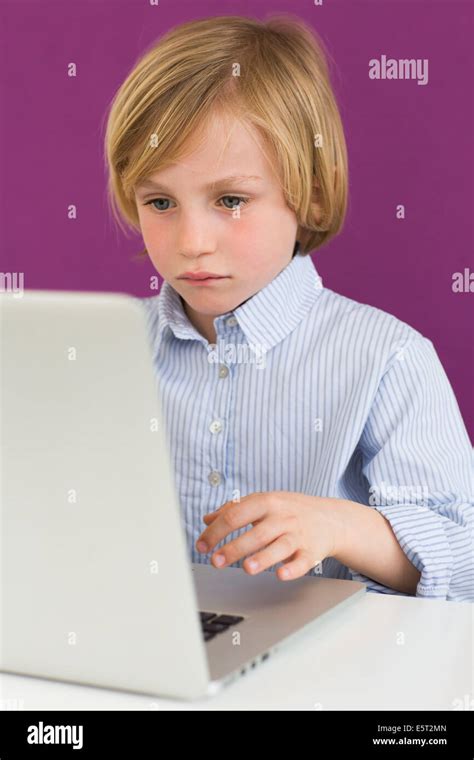 7 Year Old Boy Using A Laptop Stock Photo Alamy