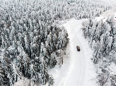 Car Driving On A Snowy Road In The Woods Free Stock Photo Picjumbo