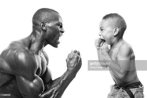 Black And White Portrait Of A Boxer And A Little Boy In A Boxing Stance