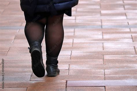 Fat Woman Walking Down The Street Thick Legs In Tights And Black Boots