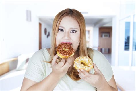 Overweight Woman Eats Two Donuts Stock Photos Free Royalty Free Stock Photos From Dreamstime