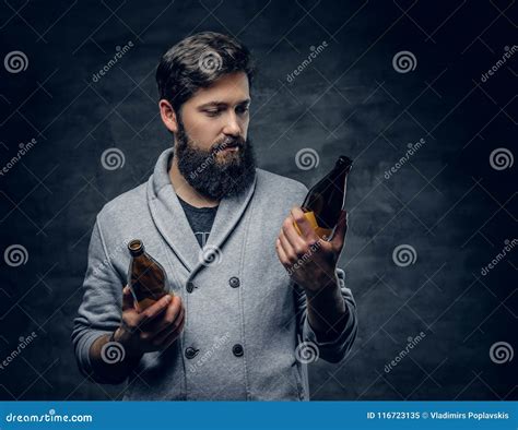 Bearded Male Looking On Two Craft Beer Bottles Stock Image Image Of