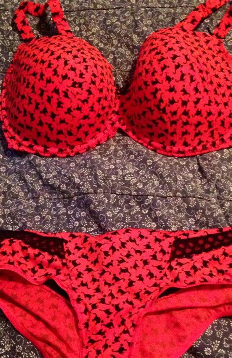 Two Red Bikinis Laying On Top Of A Bed Next To Each Other In Front Of A