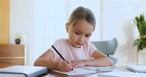 Focused Cute Little Kid Girl Doing Homework Alone Stock Video Footage