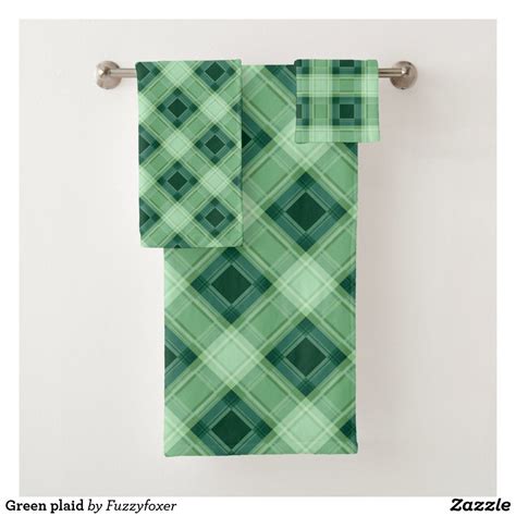 Two Green Towels Hanging On A Towel Rack
