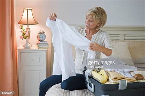 Mature Woman Packing Suitcase Photos And Premium High Res Pictures Getty Images