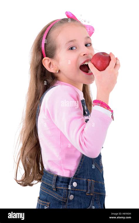 Young Blond Girl Eating Apple Isolated On White Background Stock Photo