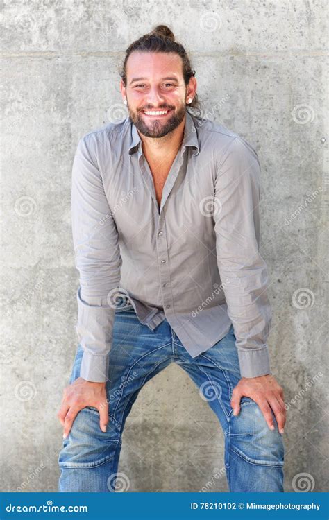 Smiling Man Leaning Forward With Hands On Knees Stock Photo Image Of