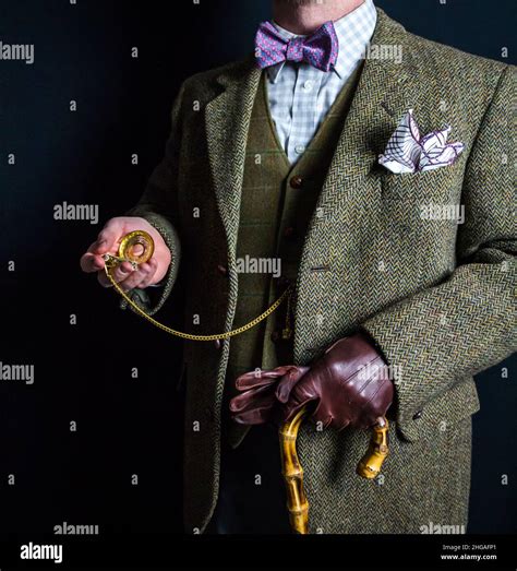 Portrait Of English Gentleman In Tweed Suit Holding Gold Pocket Watch
