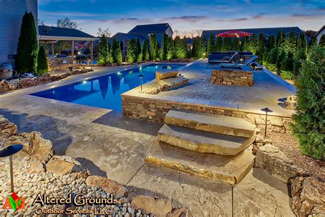Backyard Pool With Raised Stamped Concrete Patio And Natural Stone Steps Stamped Concrete