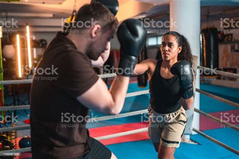 Caucasian Male And Hispanic Female Boxers Spar Fighting Stock Photo