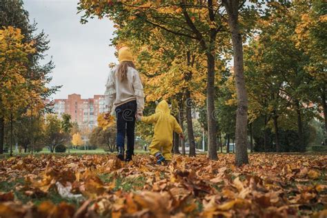 Happy Children Walk In Autumn Park Leaf Fall Lifestyle Stock Photo