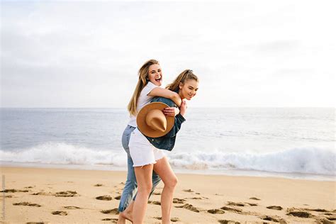 Best Of Friends Hugging And Laughing At The Beach By Stocksy Contributor Curtis Kim Stocksy