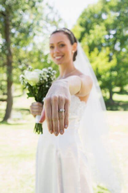 Premium Photo Bride Showing Wedding Ring In Garden