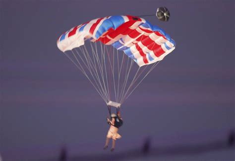 a parachutist dressed as queen elizabeth is seen during the opening ceremony of the london
