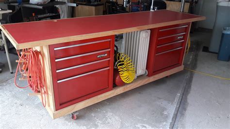 Rolling work bench made to incorporate tool chest with open clamp and