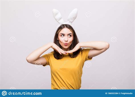 Beautiful Young Woman Wearing Cute Bunny Ears And Holding Her Head In