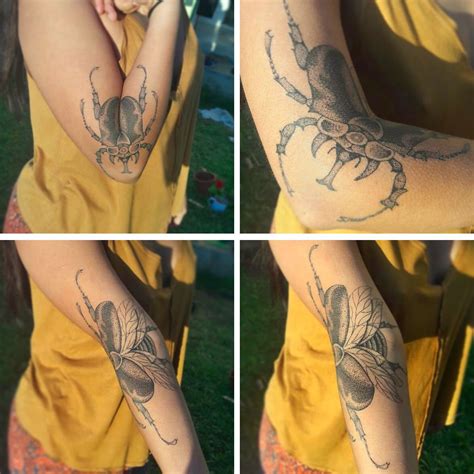 a beetle tattoo spreads its wings in tandem with its owner s arm colossal tribal tattoos