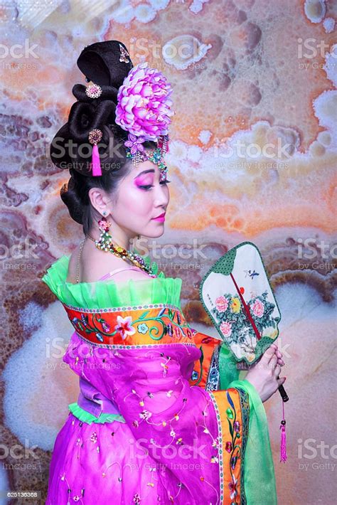 Asian Woman With Chinese Traditional Dress Holding Chinese Fan Stock