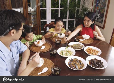 Family photo stock photos and images. Family having dinner — Stock Photo © MicrostockAsia #133478582