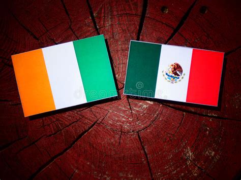 Ivory Coast Flag With Mexican Flag On A Tree Stump Isolated Stock Image