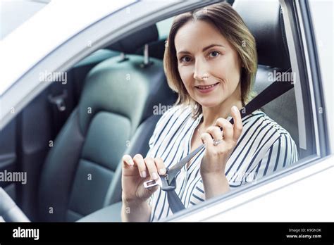 Road Safety Concept Pretty Business Woman Fastening Her Seat Belt In A Car Outdoor Photo Stock