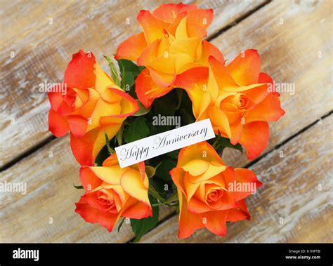 Happy Anniversary Card With Orange Roses Bouquet On Rustic Wooden