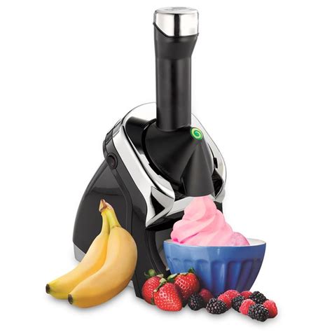 A Blender Filled With Fruit And Ice Cream Next To A Bowl Of Strawberries