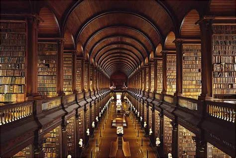 A Long Library Filled With Lots Of Books And A Quote On The Wall Above It