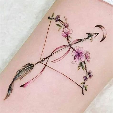 An Arrow And Flowers Tattoo On The Leg