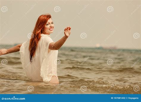 Redhead Woman Playing In Water During Summertime Stock Photo Image Of