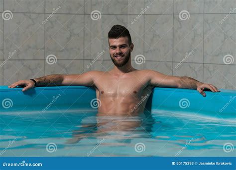 Man Resting His Arms At Edge Of Pool Stock Image Image Of Fashion