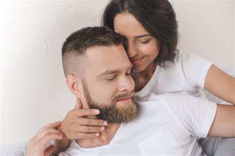 Tender Smiling Couple Embracing And Lying On Bed At Home Stock Image