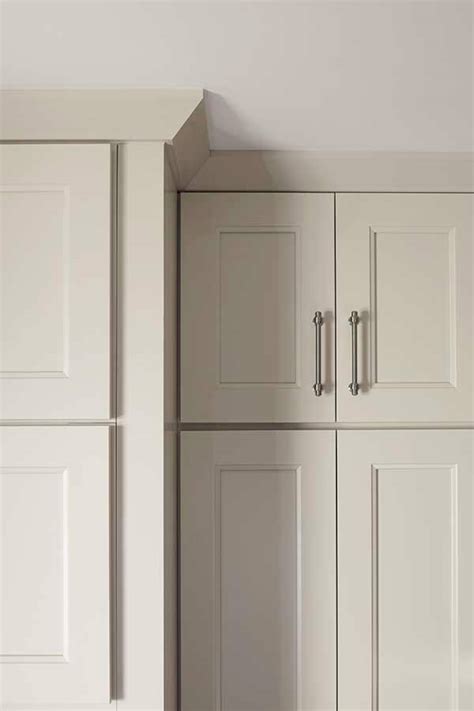 The fillers above the doors should sit flush with the door faces; Shaker Crown Moulding - Schrock Cabinetry