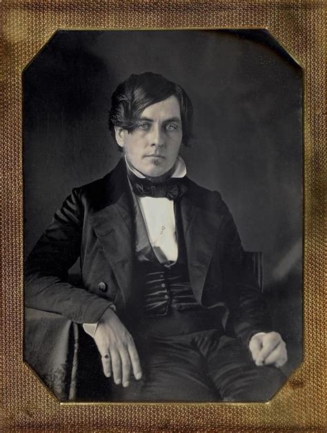 An Old Black And White Photo Of A Man In A Suit