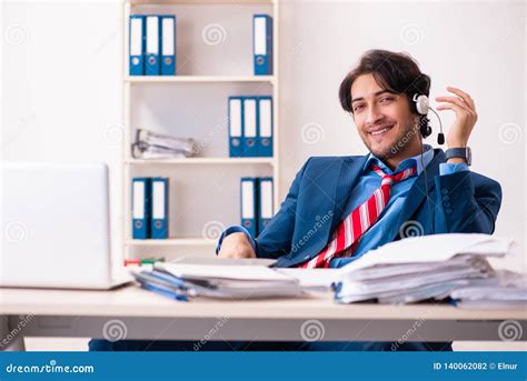 The Young Handsome Businessman Sitting In The Office Stock Photo