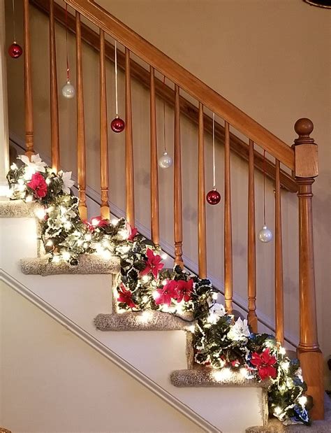 Holiday decor for a small stair rail. Red and white lighted poinsettia