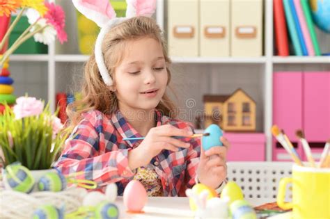 Portrait Of Happy Girl Painting Eggs For Easter Holiday Stock Image
