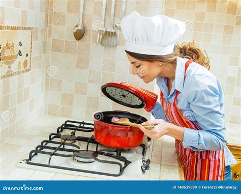 Wife Making Dinner On The Stove In A Red Pan Stock Image Image Of