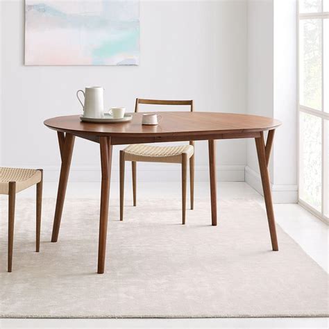 When extended, the dining table is rectangular and can easily sit 6 to 8 people. Mid-Century Expandable Dining Table - Round | west elm Canada
