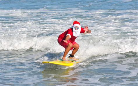Celebrate Christmas Eve With Hundreds Of Surfing Santas On Cocoa Beach