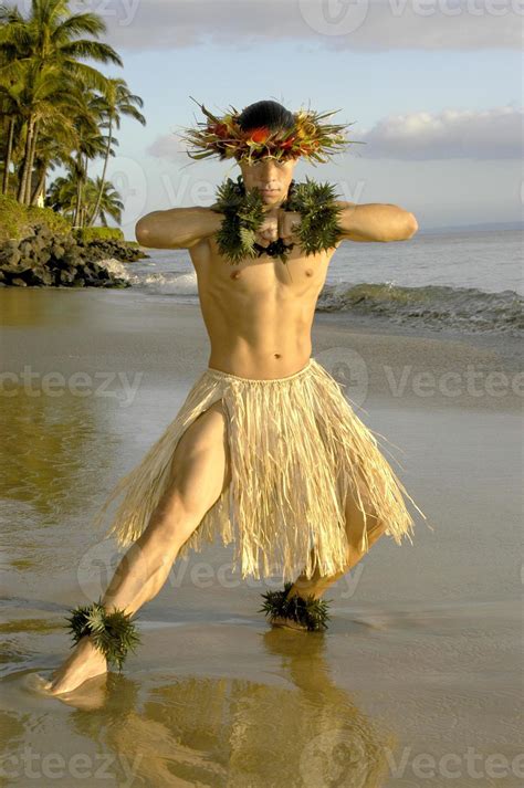 Hawaiian Male Hula Dancer Hits A Strength Pose On The Beach In Maui