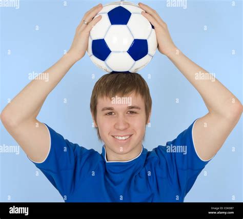 Young Man Holding Soccer Ball On Head Smiling Portrait Stock Photo