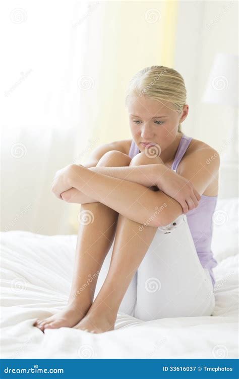 Depressed Teenage Girl Hugging Knees On Bed Royalty Free Stock Photography Image