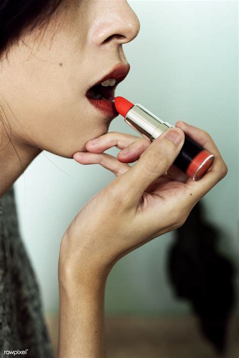 Download Premium Image Of Close Up Of A Woman Applying Lipstick 326502