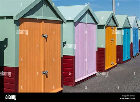 Row Of Brightly Coloured Beach Huts In Sunshine Stock Photo Alamy