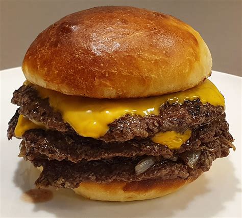Homemade Triple Smashed Burger With Cheese Onion And A Freshly Baked