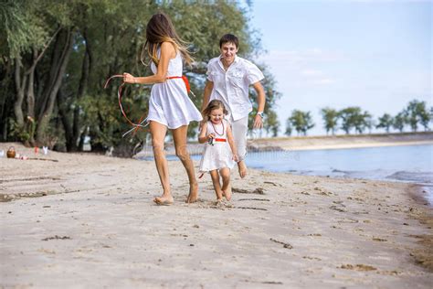 Mom Dad And Daughter Walking On The Beach Stock Image Image Of